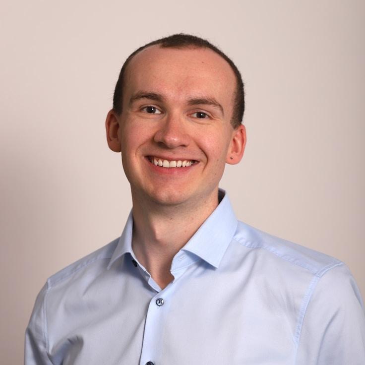 Alex Carter, Lead Design Curator at Cloud Island Nest, reviewing corporate floral arrangements